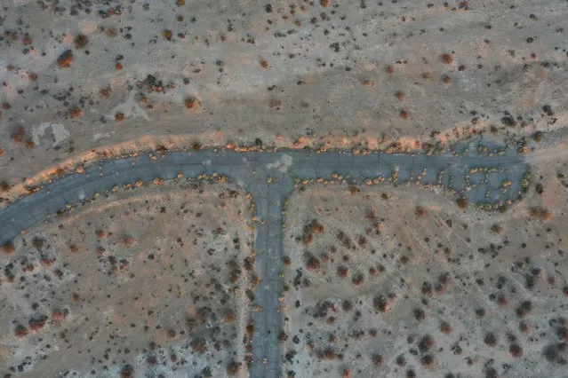 This aerial picture taken on October 1, 2021 shows a cul de sac road amid a vast network of roads cut in the Mojave Desert, intended for a massive suburban paradise that was never built, in California City, California, approximately 100 miles (160 km) north of Los Angeles. - Envisioned as a family-friendly suburban utopia by a 1950's-era real estate developer who wanted to recreate the success of desert cities such as Palm Springs and Las Vegas, he and a team of salespeople sold the dream to thousands of people. (Photo by Robyn Beck/AFP Photo)