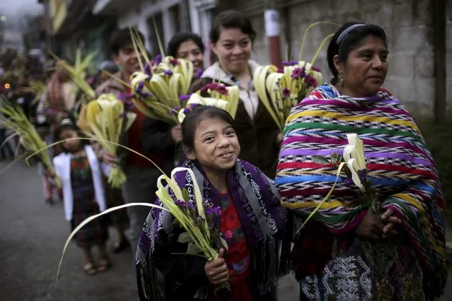 Indigenous people hold traditional palm fronds during a Catholic Palm Sunday procession on the streets of San Pedro Sacatepequez, Guatemala, March 20, 2016. (Photo by Saul Martinez/Reuters)