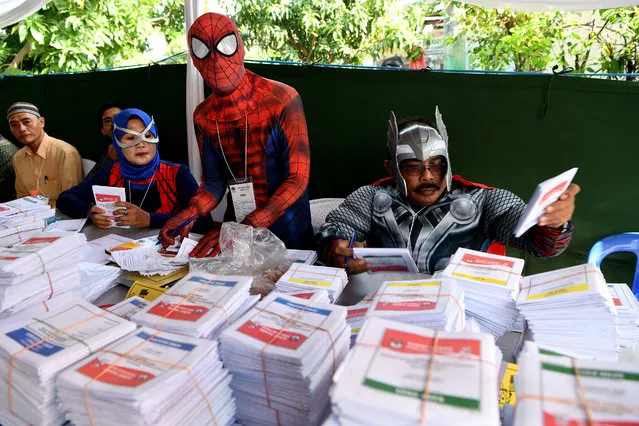 Election officials wearing superhero costumes prepare ballots at a polling station during elections in Surabaya, East Java province, Indonesia, April 17, 2019 in this photo taken by Antara Foto. Tens of millions of Indonesians were voting in presidential and legislative elections Wednesday after a campaign that pitted the moderate incumbent against an ultranationalist former general whose fear-based rhetoric warned the country would fall apart without his strongman leadership. (Photo by Zabur Karuru/Antara Foto via Reuters)