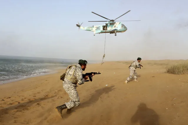 In this photo released by the official website of the Iranian Army on Sunday, November 7, 2021, troops attend a maneuver in a coastal area of southeastern Iran. On Sunday Iran's military began its annual war games near the Gulf of Oman, less than a month before upcoming nuclear talks with the West. (Photo by Iranian Army via AP Photo)