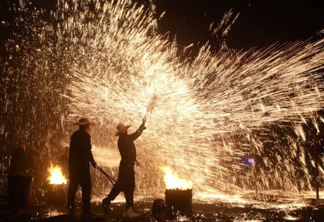 Folk artists stage a molten iron fireworks performance to celebrate the Lantern Festival on February 24, 2024 in Luding, Sichuan Province of China. Lantern Festival falls on February 24 this year. (Photo by Wang Lei/China News Service/VCG via Getty Images)