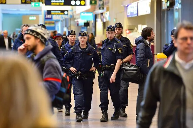 Swedish police patrol in Arlanda airport outside Stockholm, Sweden, Tuesday, March 22, 2016. More than 200 flights to Brussels have been diverted or canceled after three explosions that authorities are calling terror attacks, according to the flight tracking service Flightradar24. Scores of people are dead after two explosions hit Brussels airport Tuesday morning and a third hit the city's Maelbeek metro station. The Brussels airport has been shut down and airport security has been tightened across Europe. (Photo by Johan Nilsson/TT News Agency via AP Photo)