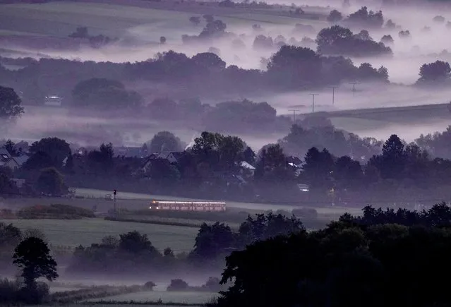 A regional train runs through the fog covered landscape in the Taunus region near Wehrheim early Tuesday, September 28, 2021. (Photo by Michael Probst/AP Photo)
