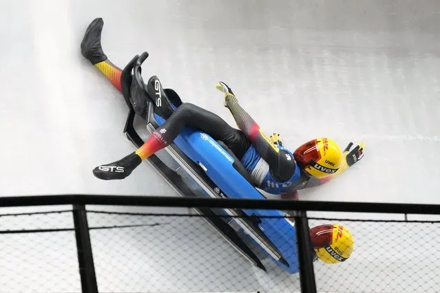 Toni Eggert and Sascha Benecken of Germany lose their sled while competing in the relay race at the Luge World Cup, a test event for the 2022 Winter Olympics, at the Yanqing National Sliding Center in Beijing, Sunday, November 21, 2021. (Photo by Mark Schiefelbein/AP Photo)