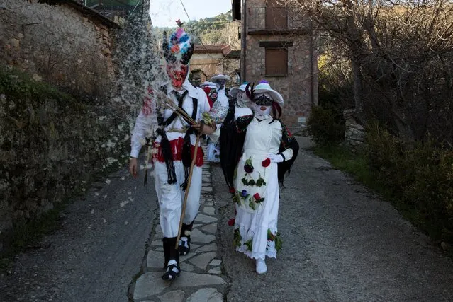 Revellers dressed as “Botargas” (L) and “Mascaritas” walk down a street during carnival celebrations in Almiruete, Spain, February 25, 2017. (Photo by Sergio Perez/Reuters)