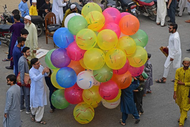 Muslim devotees buy balloons after offering Eid al-Fitr prayers, marking the end of the holy fasting month of Ramadan, in Karachi on April 10, 2024. (Photo by Asif Hassan/AFP Photo)