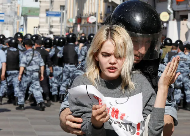 A law enforcement officer detains a participant of a rally calling for opposition candidates to be registered for elections to Moscow City Duma, the capital's regional parliament, in Moscow, Russia on July 27, 2019. (Photo by Shamil Zhumatov/Reuters)