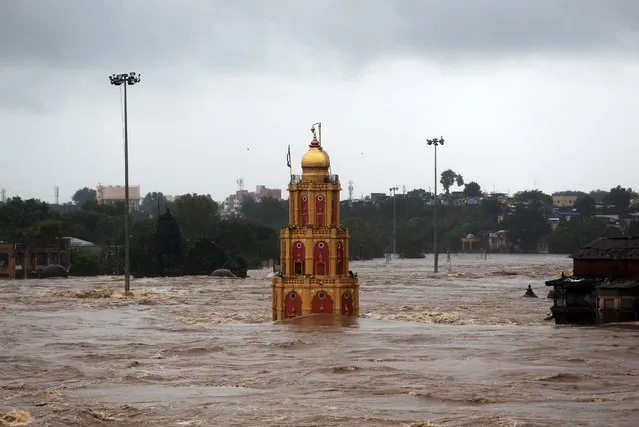 A temple is seen submerged in the waters of overflowing river Godavari after heavy rainfall in Nashik, India, August 4, 2019. (Photo by Francis Mascarenhas/Reuters)