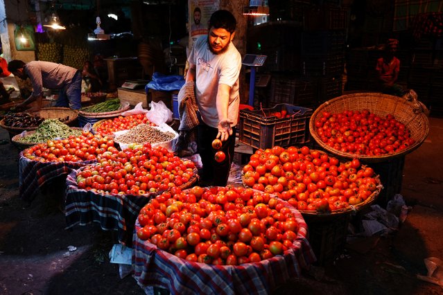 A seller sorts tomatoes at the Karwan Bazar kitchen market ahead of Ramadan in Dhaka, Bangladesh, on March 11, 2024. (Photo by Mohammad Ponir Hossain/Reuters)