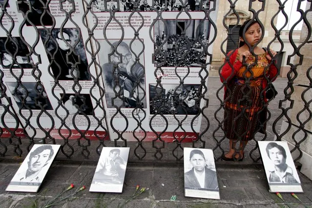 A girl stands next to pictures of missing people during a protest against the commemoration of the 144th anniversary of the founding of the Guatemalan Army, in Guatemala City June 30, 2015. (Photo by Josue Decavele/Reuters)