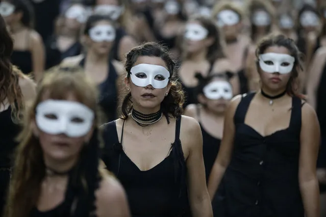 In this March 24, 2017 photo, activists march to mark the 41th anniversary of the military coup in Buenos Aires, Argentina. Tens of thousands of people marched to mark the 41th anniversary of the military coup that led to the 1976-83 dictatorship. (Photo by Victor R. Caivano/AP Photo)