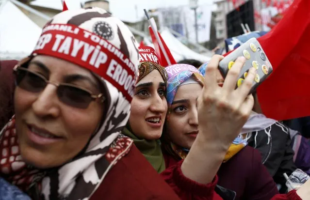 Supporters of Turkish President Tayyip Erdogan take a selfie as they wait for the start of a rally for the upcoming referendum in the Kurdish-dominated southeastern city of Diyarbakir, Turkey, April 1, 2017. (Photo by Murad Sezer/Reuters)