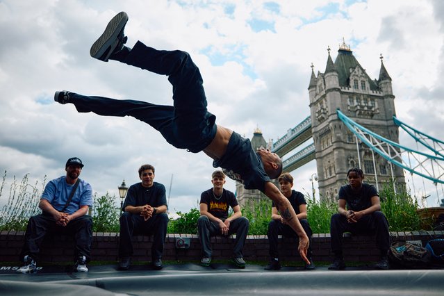A breakdancer performs during a UK breakdancing (breaking) event held beside The River Thames in London on May 29, 2024. While spinning on his head in the shadow of London's Tower Bridge, B-Boy Kid Karam has his sights set firmly on the Paris Olympics. The 26-year-old athlete is hoping to be in French capital when breakdancing, or “breaking” as the sport is officially known, makes its Olympic debut. (Photo by Benjamin Cremel/AFP Photo)