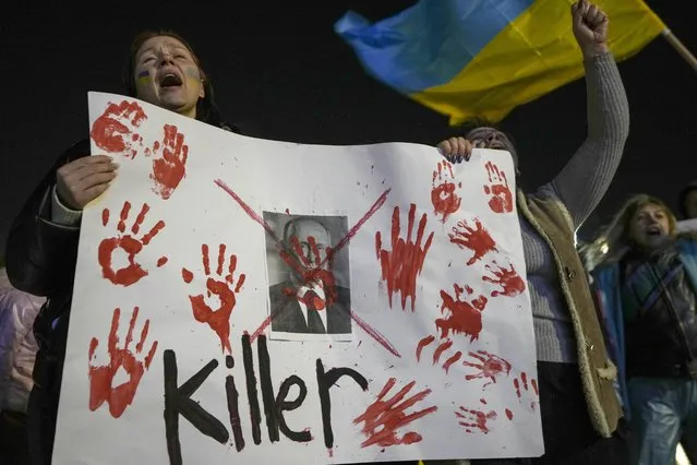 Women hold a placard against Russian President Vladimir Putin as they attend a pro-Ukraine protest against Russia's invasion of Ukraine in Tel Aviv, Israel, Thursday, March 3, 2022. (Photo by Ariel Schalit/AP Photo)