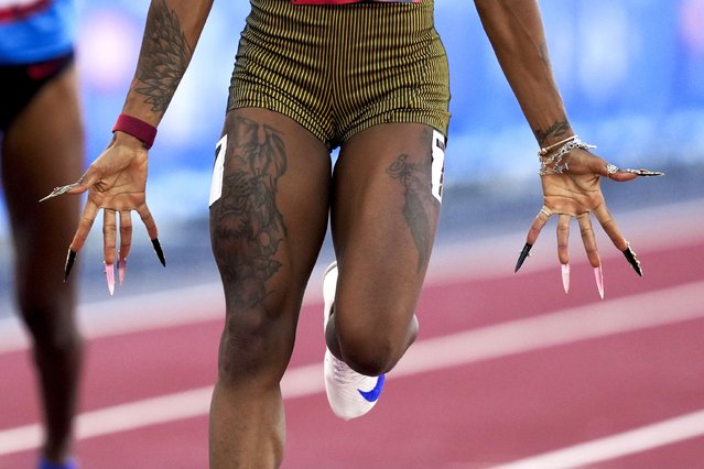 Sha'Carri Richardson, shows her long finger nails, as she wins a heat women's 100-meter run during the U.S. Track and Field Olympic Team Trials Friday, June 21, 2024, in Eugene, Ore. (Photo by Charlie Neibergall/AP Photo)