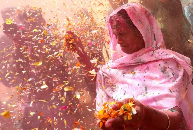 Indian widows throw flower petals while participating in the Holi festival in Vrindavan, Uttar Pradesh, India, 15 March 2022. (Photo by Harish Tyagi/EPA/EFE)