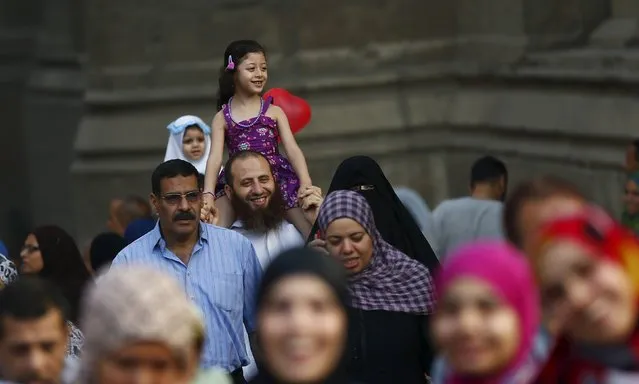 Egyptian Muslims smile after Eid-al-Fitr prayers in the old Islamic area of Cairo, Egypt, July 17, 2015. (Photo by Amr Abdallah Dalsh/Reuters)