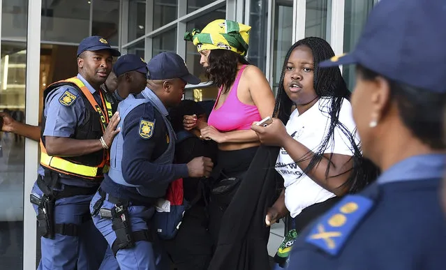 Protesters break through a police cordon to gain entry where the World Economic Forum on Africa is being held in Cape Town, South Africa, Wednesday, September 4, 2019. The women are demanding that the government crack down on gender-based violence, following a week of brutal murders of young South African women that has shaken the nation. (Photo by AP Photo/Stringer)