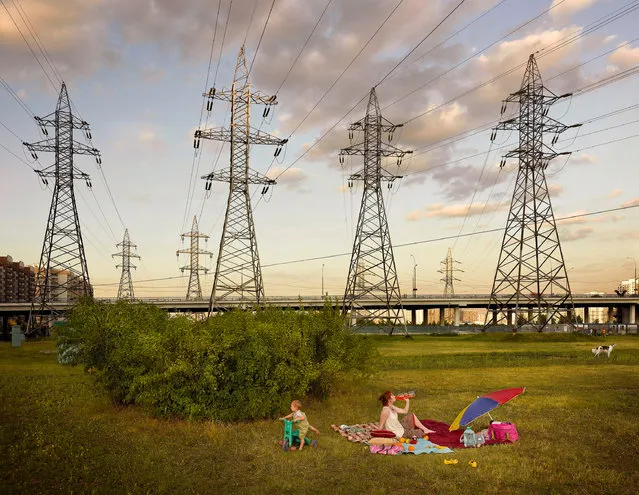 A young family picnics beneath power lines in a residential area of Maryino, Moscow. (Photo by by Frank Herfort/The Guardian)