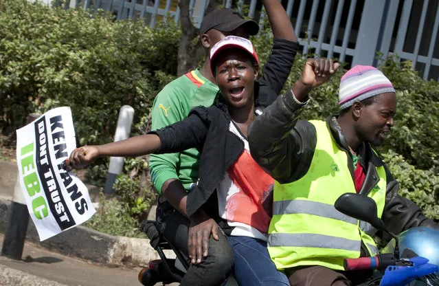 A demonstrator carries a placard using the acronym of the national electoral commission, at a protest calling for the disbandment of the commission over allegations of bias and corruption, in downtown Nairobi, Kenya Monday, June 6, 2016. (Photo by Sayyid Azim/AP Photo)