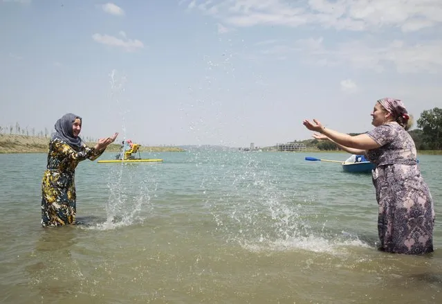 Chechen women enjoy themselves in the water on the outskirts of the regional Chechen capital of Grozny, Russia, Tuesday, August 3, 2015. The beach outside Grozny will be off-limits to men in line with Islamic rules after its inauguration on Tuesday. A separate beach for men is to open later. (Photo by Musa Sadulayev/AP Photo)