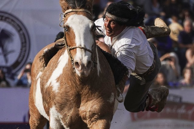 A man wearing traditional clothing performs acrobatics on a horse during Independence Day celebrations in Santiago, Chile, Tuesday, September 17, 2024. (Photo by Matias Basualdo/AP Photo)