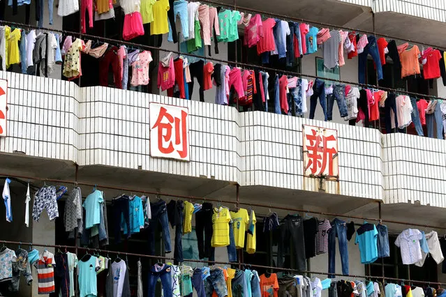 Clothes are hung at a student dormitory in Ji'an, Jiangxi Province, China, June 13, 2016. The characters read, “Innovation”. (Photo by Reuters/China Daily)
