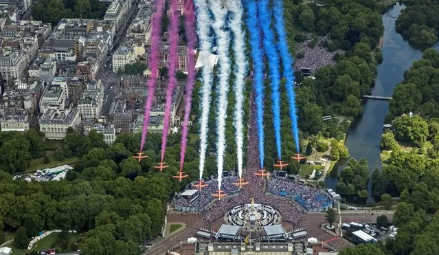 The Red Arrows perform a flypast after the Trooping the Colour ceremony in London, Thursday June 2, 2022, on the first of four days of celebrations to mark the Platinum Jubilee. The events over a long holiday weekend in the U.K. are meant to celebrate the monarch's 70 years of service. (Photo by RAF SAC Sarah Barsby, Ministry of Defence via AP Photo)