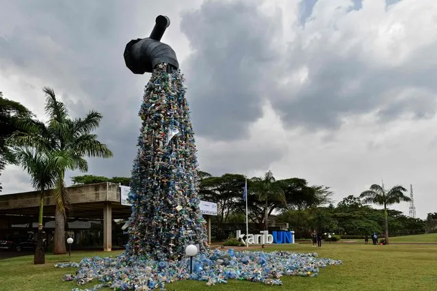 A thirty-foot monument themed 'turn off the plastics tap' by Canadian activist and artist, Benjamin von Wong, using plastic waste retreived from Nairobi's largest slum, Kibera, stands outside the venue of the Fifth Session of the United Nations Environment Assembly,(UNEA-5), at the United Nations Environment Programme (UNEP) Headquarters in Nairobi on February 22, 2022. The world has a rare opportunity to clean up the planet for future generations by uniting behind an ambitious treaty to tackle plastic trash, the UN environment chief told AFP. (Photo by Tony Karumba/AFP Photo)