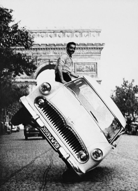 How not to drive is illustrated in this stunt, driving down the Champs Elysees in Paris, France, June 6, 1959. Jean Sunny from an auto rodeo is at the wheel and his friend hanging out the passenger side window is Mustache, a stunt man. The scene was filmed at 6 a.m. for film on safety. (Photo by Jacques Marqueton/AP Photo)