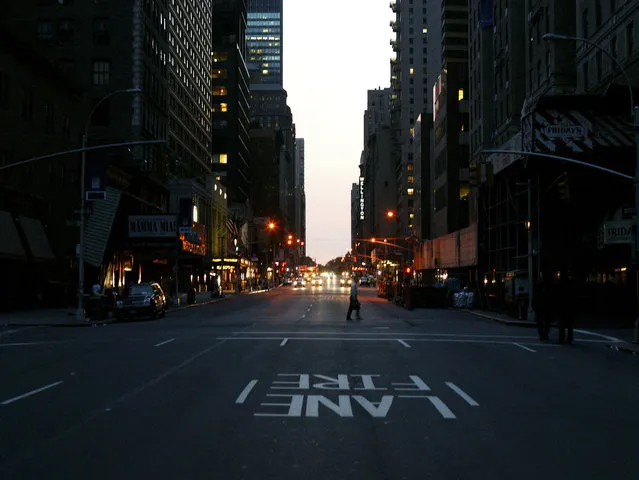 The first lights come on at 53rd and Broadway during the east coast blackout August 15, 2003 in New York City. (Photo by Matthew Peyton/Getty Images)