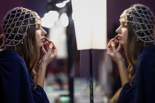 A model prepares backstage at the first Ukrainian Fashion Week since the beginning of Russia's attack on Ukraine, in Kyiv, Ukraine on September 3, 2024. (Photo by Alina Smutko/Reuters)