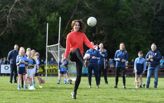 Britain's Catherine, Duchess of Cambridge reacts as she plays Gaelic football during a visit to the local Salthill Knocknacarra Gaelic Athletic Association Club (GAA) in Galway, Ireland on March 5, 2020. (Photo by Facundo Arrizabalaga/Pool via Reuters)
