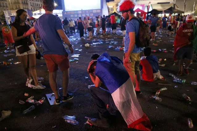 France fans react after their loss to Portugal at the fan zone during the Portugal vs France EURO 2016 final soccer match in Lyon, France, July 10, 2016. (Photo by Robert Pratta/Reuters)