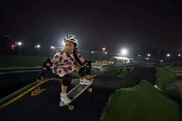Zhang Qianqian, 9, a junior member of Beijing Girls Surfskating Community, rides a skateboard at a pump track in Beijing, China on June 10, 2022. (Photo by Tingshu Wang/Reuters)