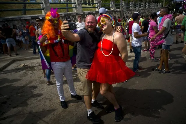 In this Saturday, May 13, 2017 photo, Henry Dougherty, right, of Minneapolis, Minn., poses for a photo with Cuban photographer Ernesto Mastrascusa, during a gay pride march in support of the fight for tolerance and acceptance of the LGBT community, in Havana, Cuba. The march commemorates the upcoming International Day Against Homophobia and Transphobia, celebrated globally on May 17. (Photo by Ramon Espinosa/AP Photo)