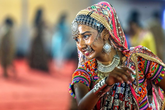 A young woman wearing traditional attire participates in a Garba dance performance during Navaratri festival celebrations in Mumbai, India, 16 October 2023. The word Navaratri literally means “nine nights” in Sanskrit. During Navaratri, nine forms of Durga (Hindu Mother Goddess) are worshiped. Navaratri is a festival of worship, dance and music celebrated over a period of nine nights, the tenth day is commonly referred as Vijayadashami or Dussehra. (Photo by Divyakant Solanki/EPA)