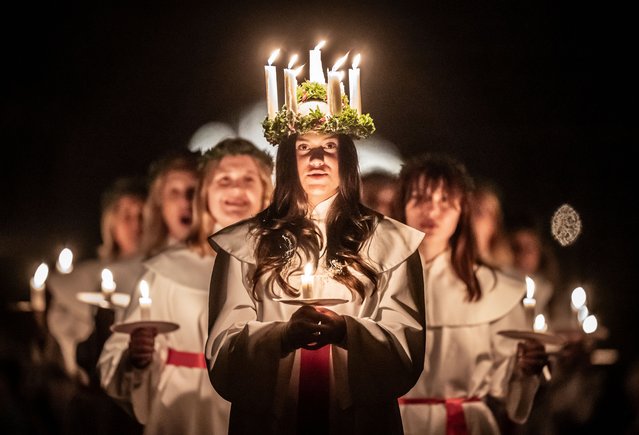 Alida Freding wears a crown of candles symbolising St Lucy as she leads the celebration of Sankta Lucia: Festival of Light at York Minster, based on the bravery and martyrdom of a young Sicilian girl St Lucy who died in the early fourth century. The service is run as a partnership between York Minster and York Anglo-Scandinavian Society (YASS) on Monday, December 16, 2024. In Sweden, Lucia is one of the most significant traditions in the calendar, a symbol and celebration of light and a part of the Advent season. Her name and story reached Sweden along with Christianity and she remained popular even after the Reformation as the bringer of light during the long darkness of winter. (Photo by Danny Lawson/PA Images via Getty Images)