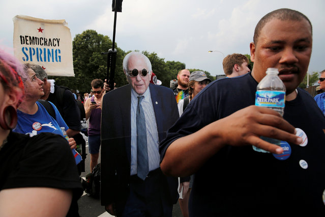 A cardboard cutout of Bernie Sanders is seen amongst the crowd during a protest at the Democratic National Convention in Philadelphia, Pennsylvania, U.S., July 25, 2016. (Photo by Andrew Kelly/Reuters)