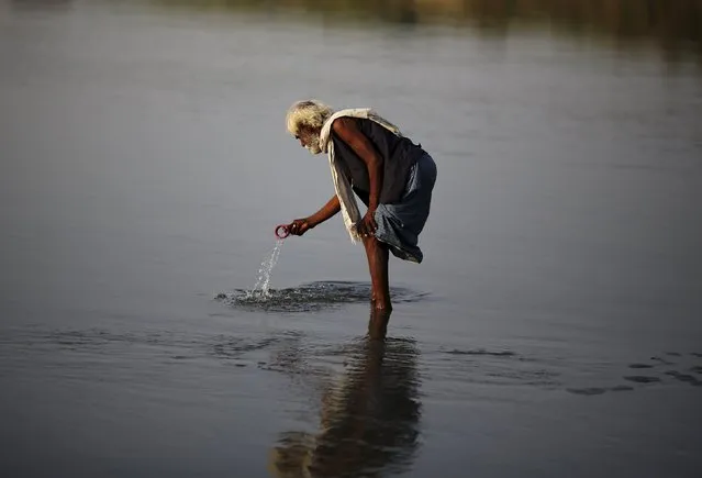 A man searches for valuables in the water of river Yamuna in New Delhi, India, August 31, 2015. (Photo by Adnan Abidi/Reuters)