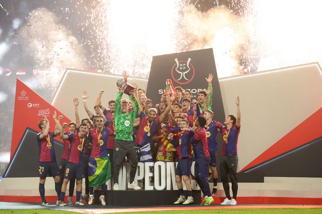Barcelona's players celebrate with the trophy after winning the Spanish Super Cup final football match between Real Madrid and Barcelona at the King Abdullah Sport City in Jeddah on January 12, 2025. (Photo by Haitham Al-Shukairi/AFP Photo)