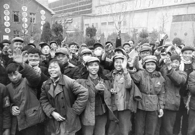 In this January 23, 1967, file photo, young workers gather outside a factory waving copies of the collected writings of Communist Party Chairman Mao Zedong, often referred to as Mao's Little Red Book. (Photo by AP Photo/File)
