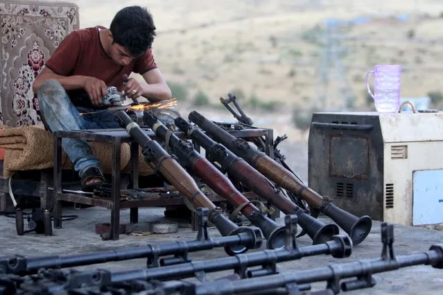 A Kurdish man repairs weapons for Kurdish Peshmerga forces fighting against Islamic State militants, in his shop outside of Arbil, north of Iraq, September 15, 2015. (Photo by Azad Lashkari/Reuters)