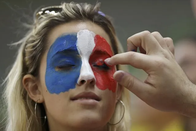 2016 Rio Olympics, Handball, Preliminary, Men's Preliminary Group A France vs Denmark, Future Arena, Rio de Janeiro, Brazil on August 15, 2016. A France fan has her face painted in the colors of the French flag. (Photo by Damir Sagolj/Reuters)