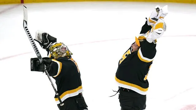 Boston Bruins goaltender Jeremy Swayman, left, celebrates with Linus Ullmark after defeating the Detroit Red Wings 5-1, following an NHL hockey game, Thursday, October 27, 2022, in Boston. (Photo by Charles Krupa/AP Photo)