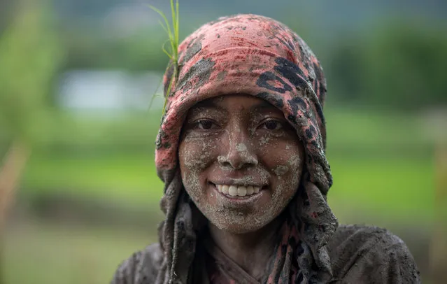 A woman covered in mud smiles in a rice paddy field during the National Paddy Day in Kathmandu, Nepal on June 29, 2020. Nepalese farmers celebrate National Paddy Day which marks the start of the annual rice planting season. (Photo by Bivas Shrestha/SOPA Images/Rex Features/Shutterstock)