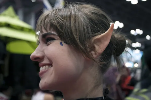 An attendee with prosthetic elf ears poses inside New York's Comic-Con convention. (Photo by Siemond Chan)