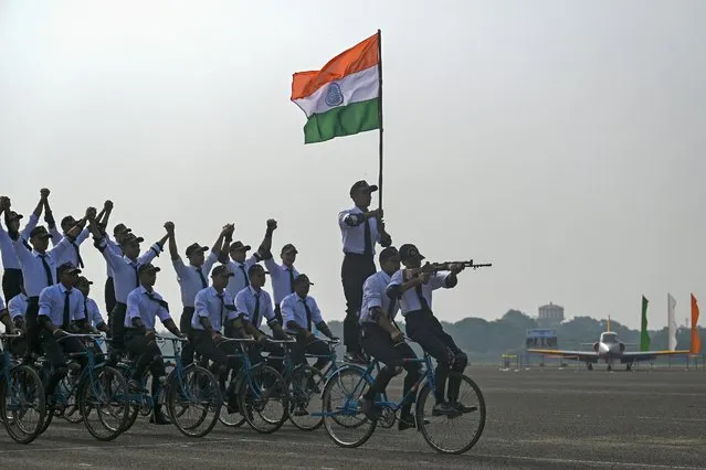 Indian Airforce cadets ride bicycles while performing a drill during a graduation ceremony at Tambaram Air Force station in Chennai on November 18, 2022. (Photo by Arun Sankar/AFP Photo)