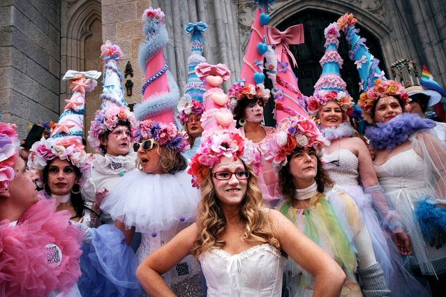 Revelers wearing decorated hats and costumes participate in the annual Easter Parade and Bonnet Festival in front of St. Patrick's Cathedral on Sunday, April 20, 2025, in New York. (Photo by Andres Kudacki/AP Photo)