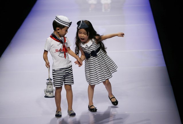 Child models present creations at Dong Wenmei T100 Children's Collection during China Fashion Week in Beijing October 29, 2014. (Photo by Kim Kyung-Hoon/Reuters)